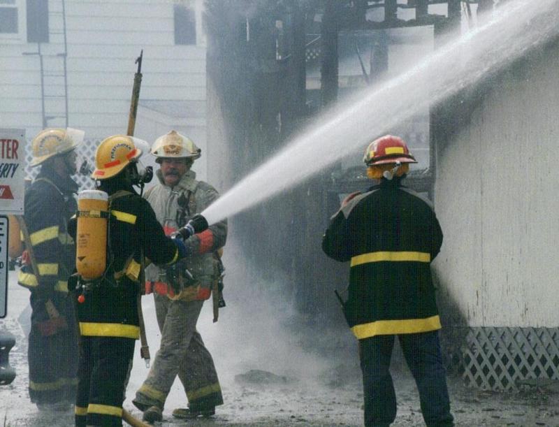 Chief Vinny Gaccione works at a fire in Misquamicut with fellow firefighters. 